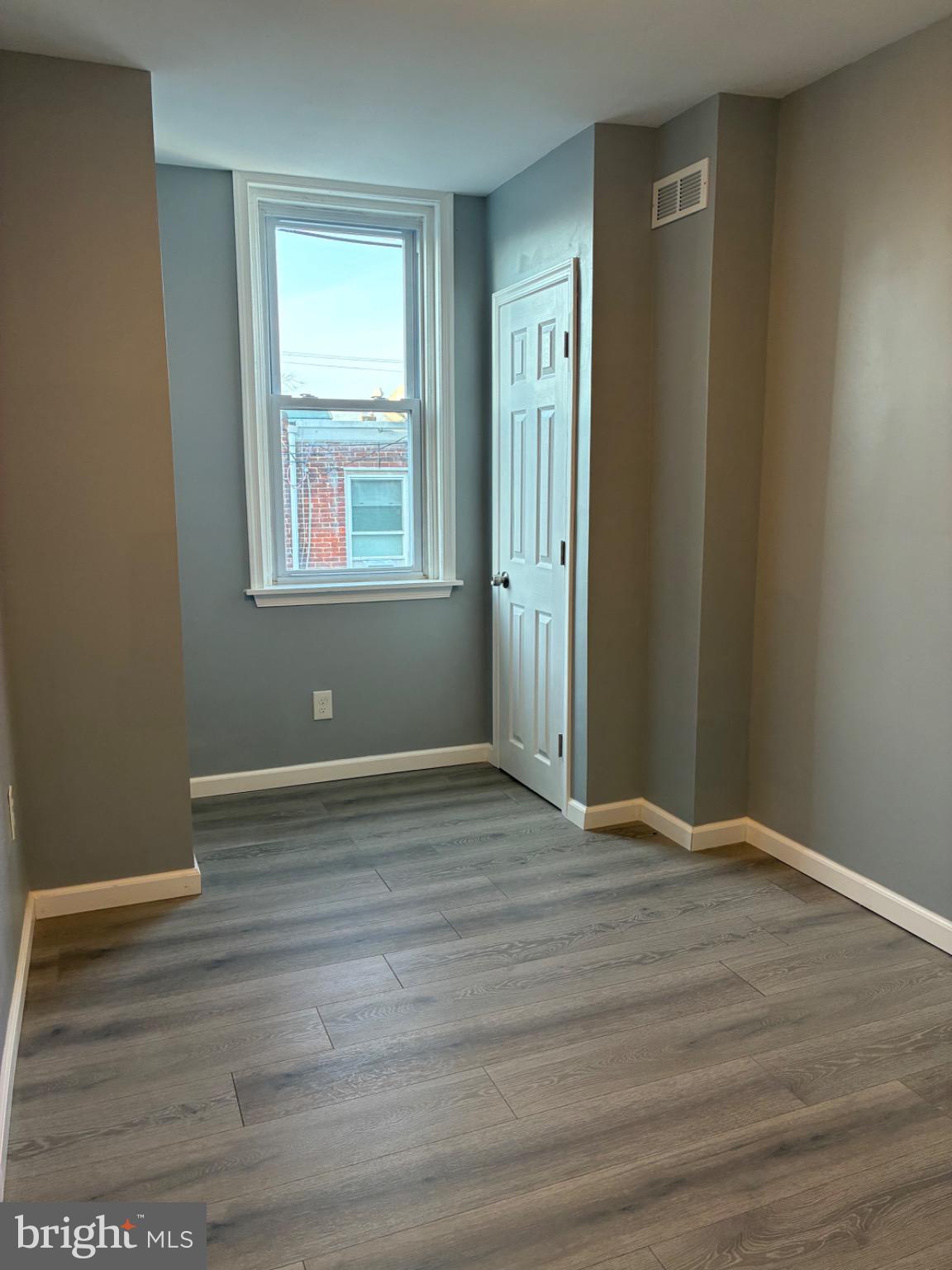 6733 Linmore Avenue Philadelphia, PA 19142 - Photo 55 of 55 a view of an empty room with wooden floor and a window
