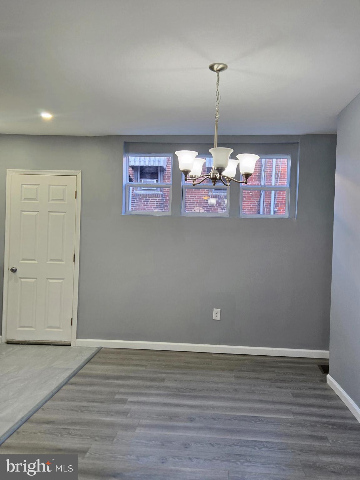 6733 Linmore Avenue Philadelphia, PA 19142 - Photo 9 of 55 an empty room with wooden floor and windows