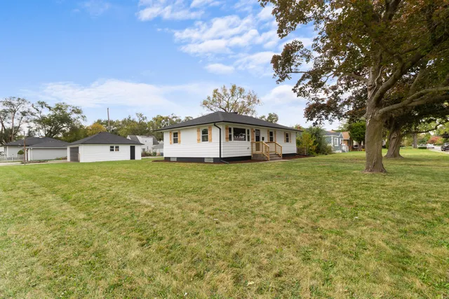 a front view of a house with a big yard