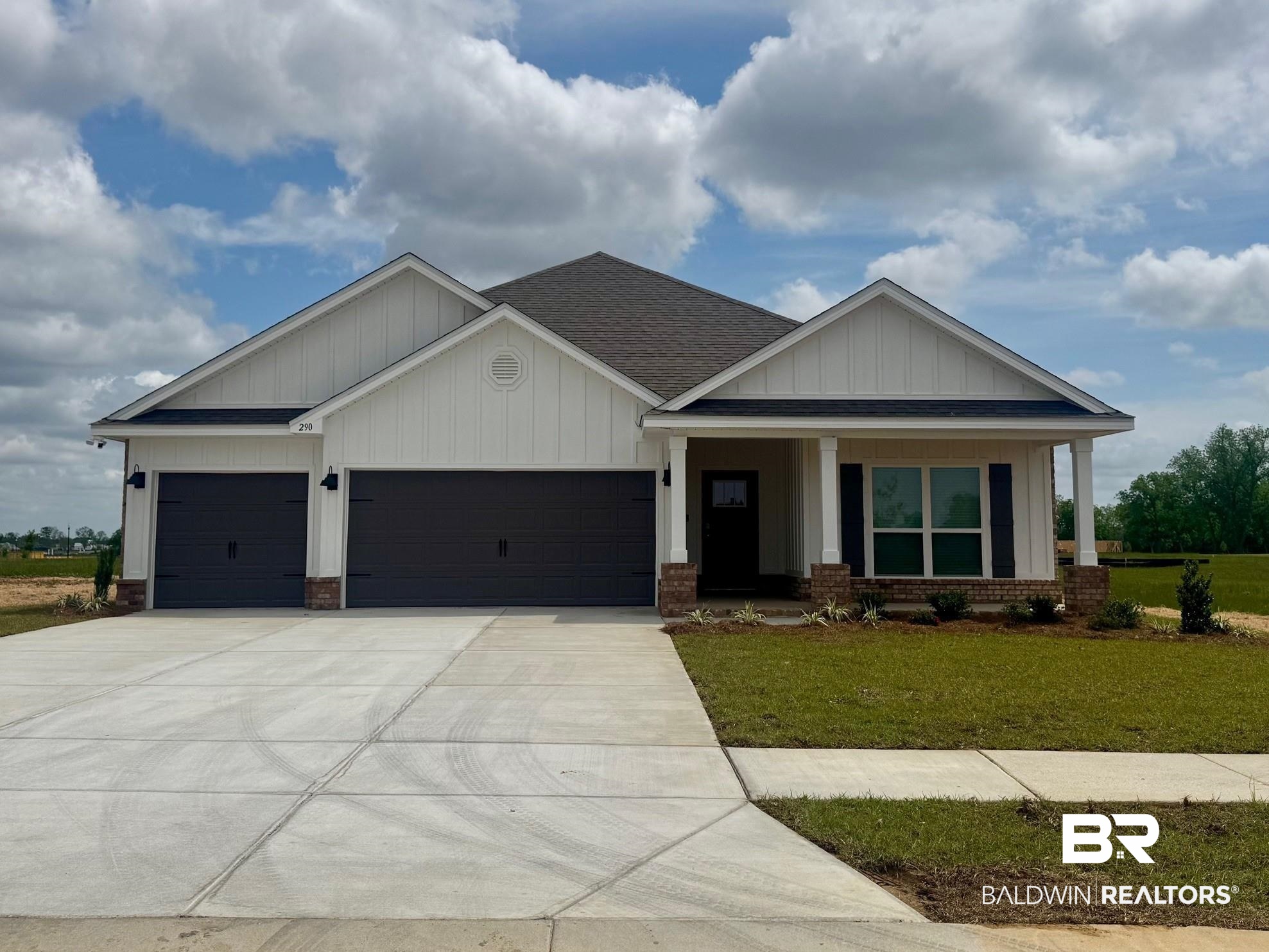 290 Tillage Street Fairhope, AL 36532 - Photo 1 of 37 View of front of house with board and batten siding, driveway, roof with shingles, a front yard, and an attached garage