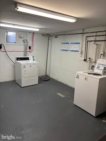 a utility room with cabinets washer and dryer