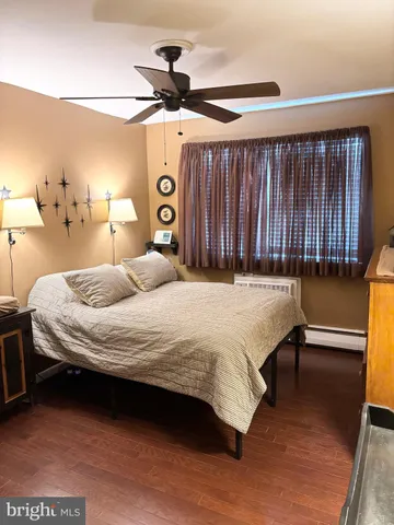 a bedroom with a bed and a night stand