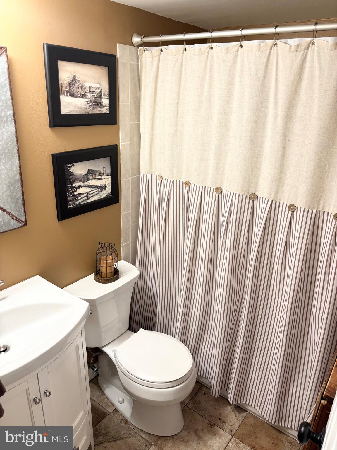 4701 Pennell Road, Unit F7 Aston, PA 19014 - Photo 7 of 13 a white toilet sitting next to a shower curtain