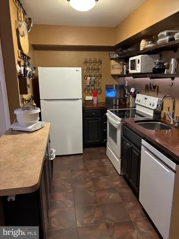 a kitchen with stainless steel appliances granite countertop a refrigerator and a stove