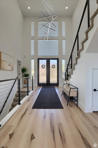 828 South Deer Road Tooele, UT 84074 - Photo 9 of 51 Grand two-story foyer featuring a striking modern chandelier and light wood-finish flooring