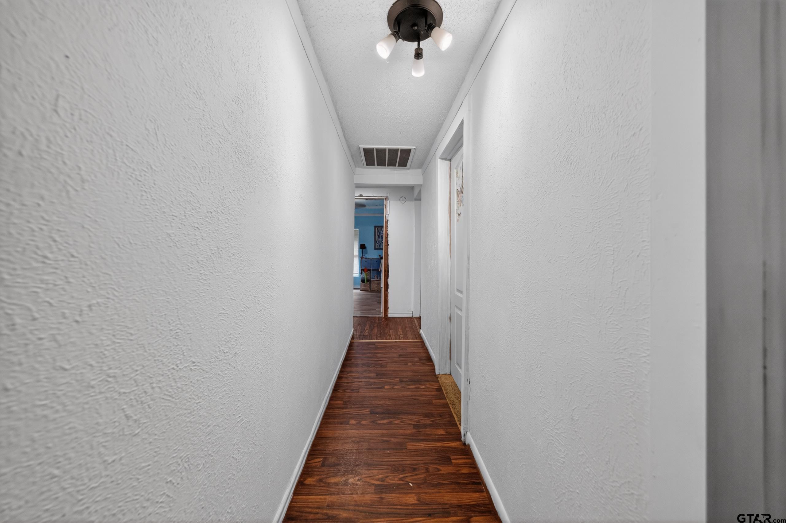 319 McArthur Street Athens, TX 75751 - Photo 13 of 33 a view of a hallway with wooden floor