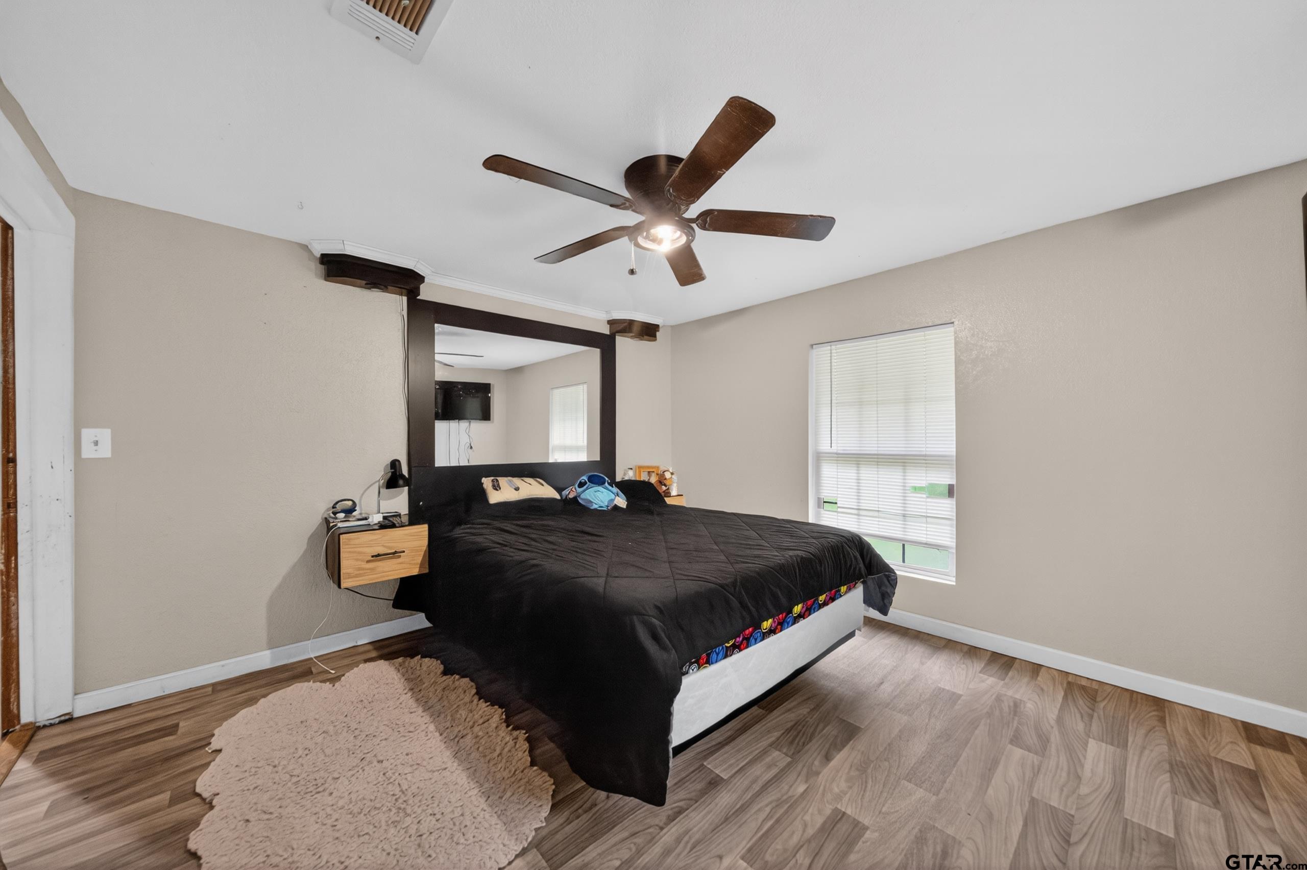 319 McArthur Street Athens, TX 75751 - Photo 17 of 33 a bedroom with a bed and window