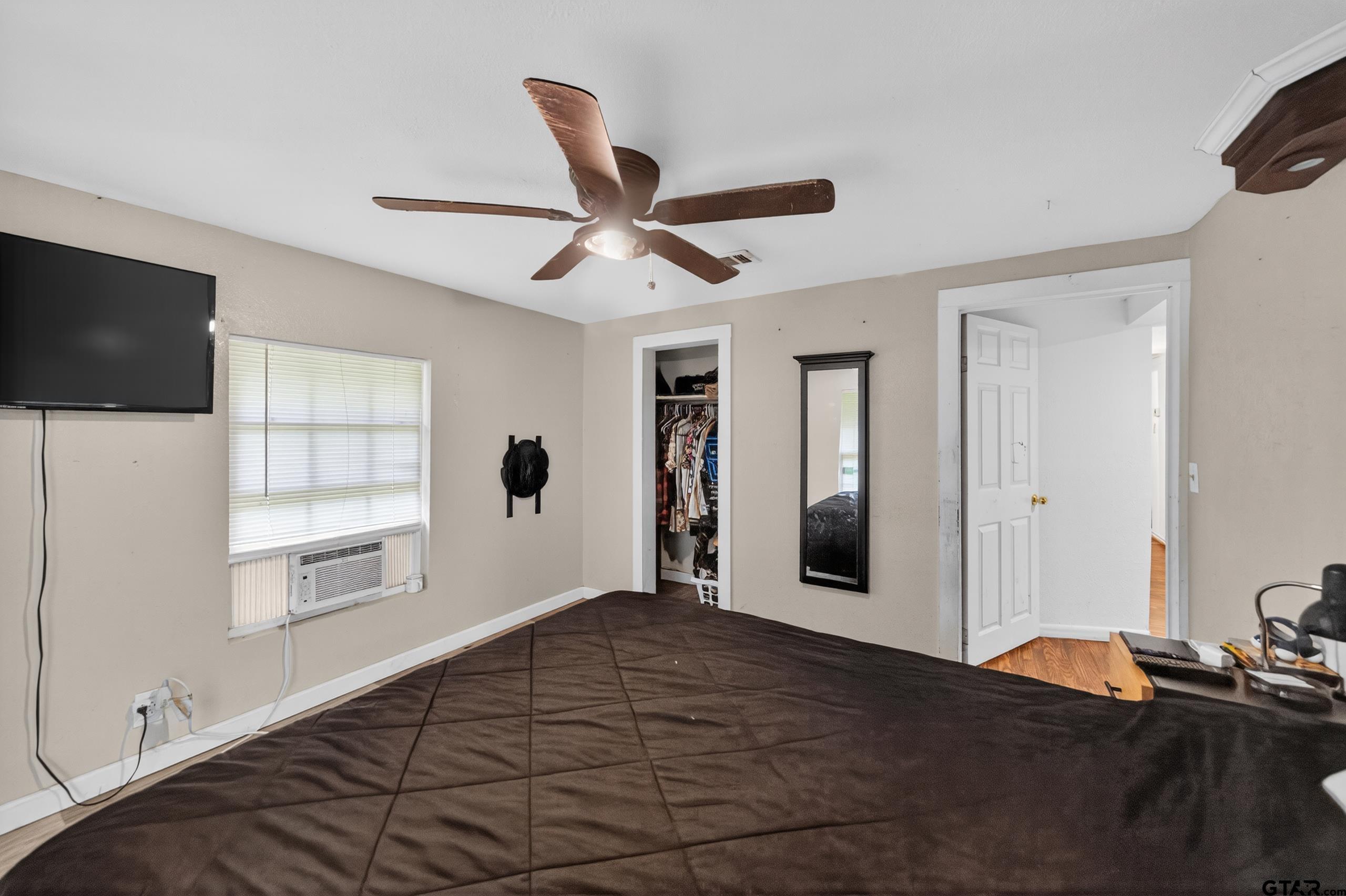 319 McArthur Street Athens, TX 75751 - Photo 19 of 33 a bedroom with a bed and a flat screen tv