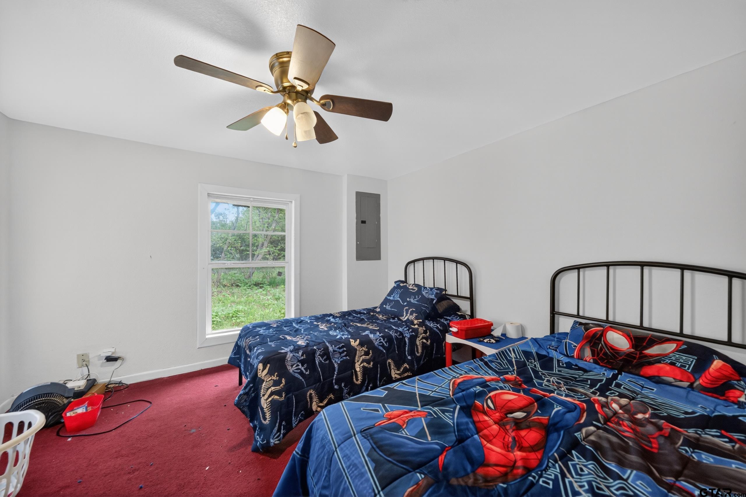 319 McArthur Street Athens, TX 75751 - Photo 23 of 33 a bedroom with two beds and a chandelier