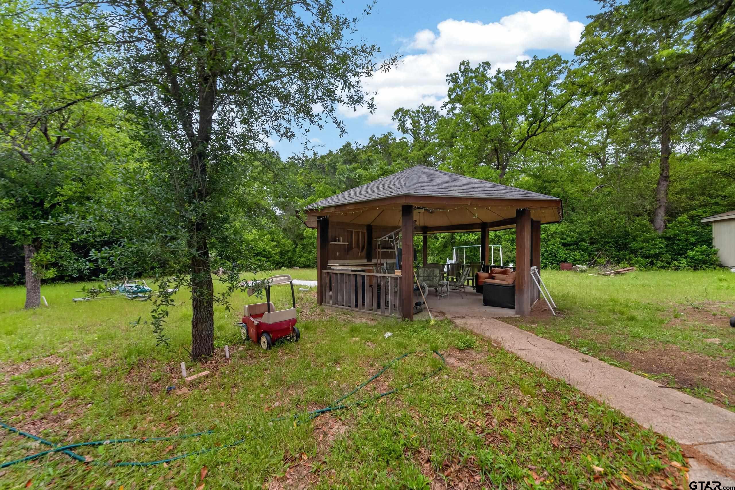 319 McArthur Street Athens, TX 75751 - Photo 29 of 33 a view of a patio with furniture and a yard