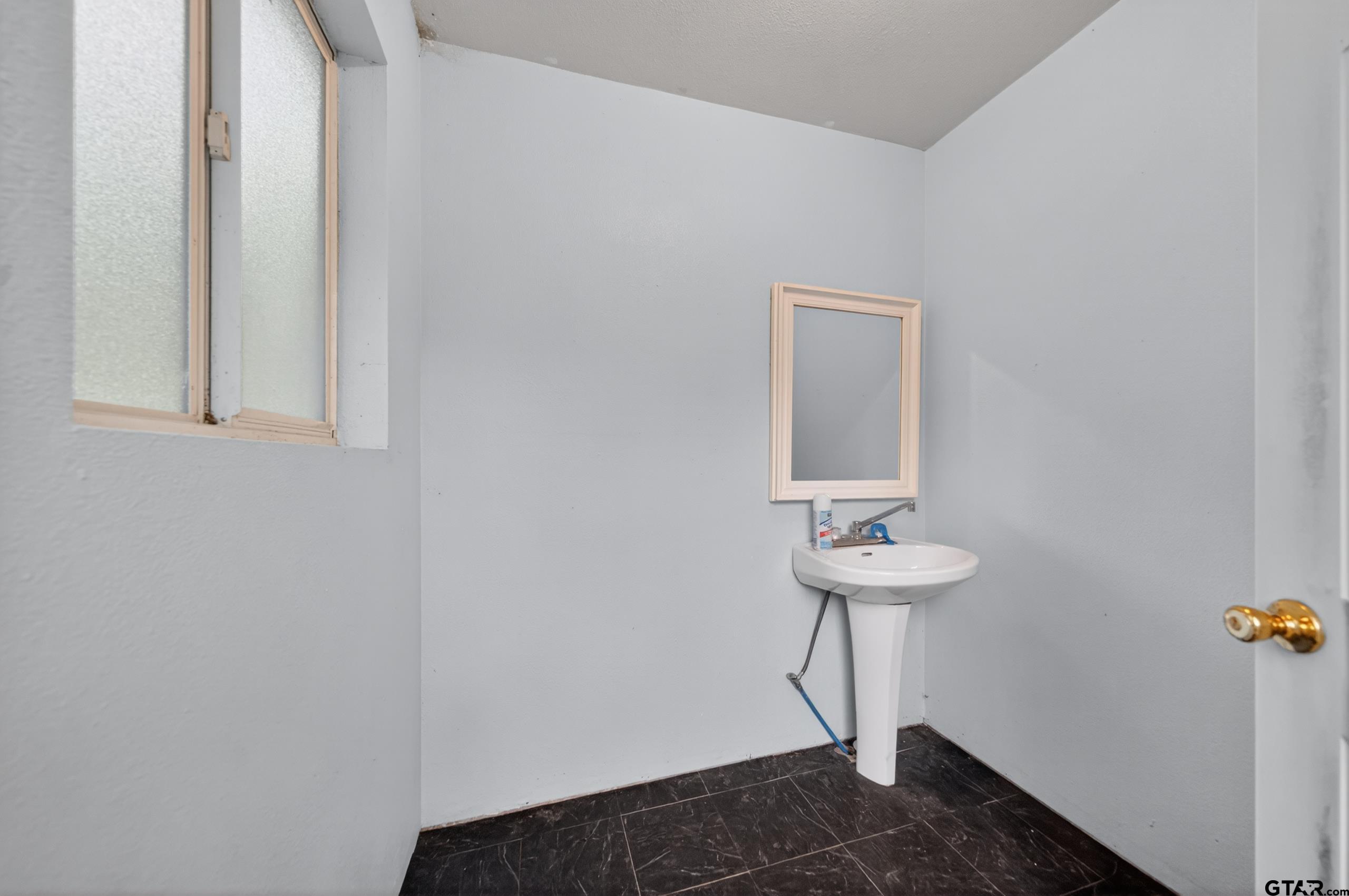 319 McArthur Street Athens, TX 75751 - Photo 33 of 33 a bathroom with a sink and a mirror