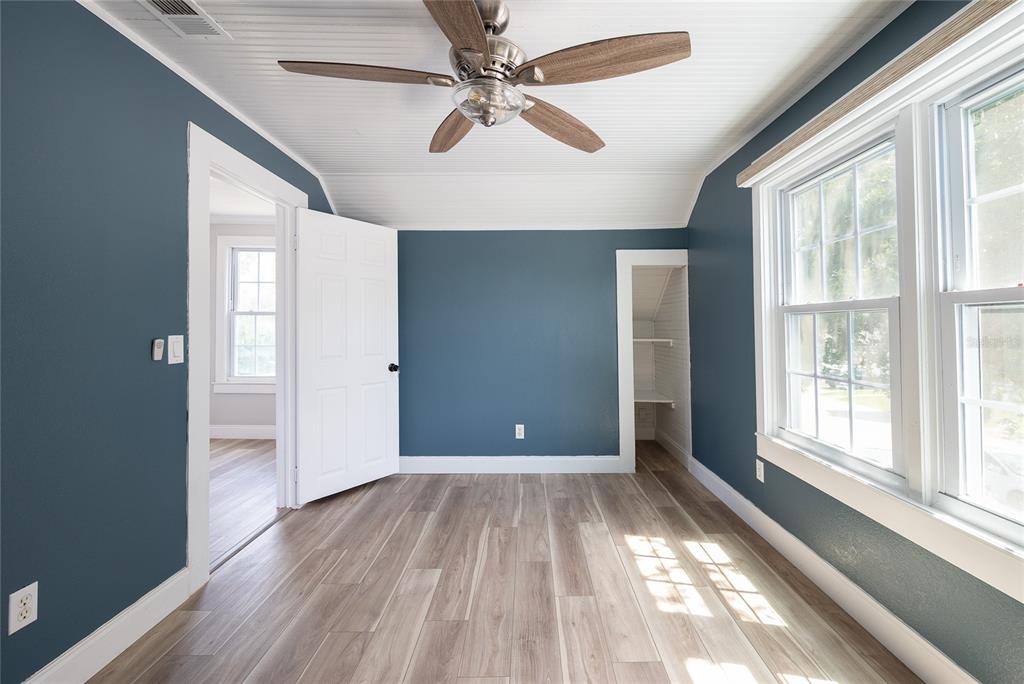 922 Delaware Avenue St. Cloud, FL 34769 - Photo 16 of 31 a view of empty room with wooden floor and fan