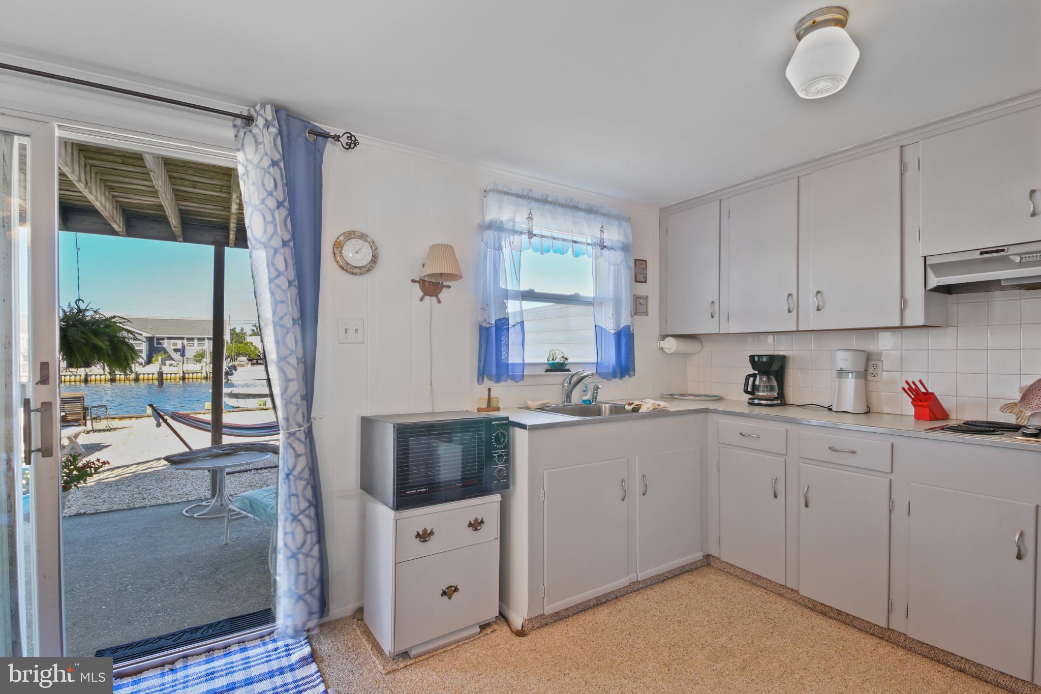 33 Adrian Road Long Beach Township, NJ 08006 - Photo 12 of 31 a kitchen with cabinets a sink and appliances