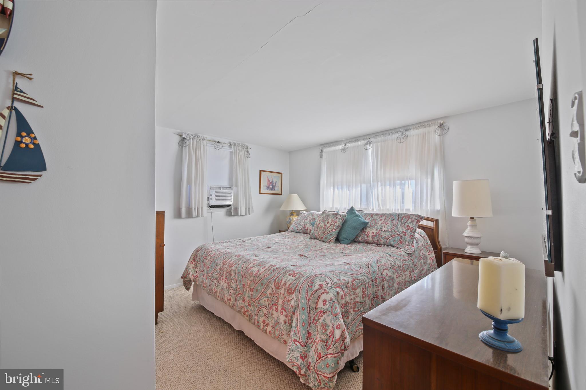 33 Adrian Road Long Beach Township, NJ 08006 - Photo 13 of 31 a bedroom with a bed and window
