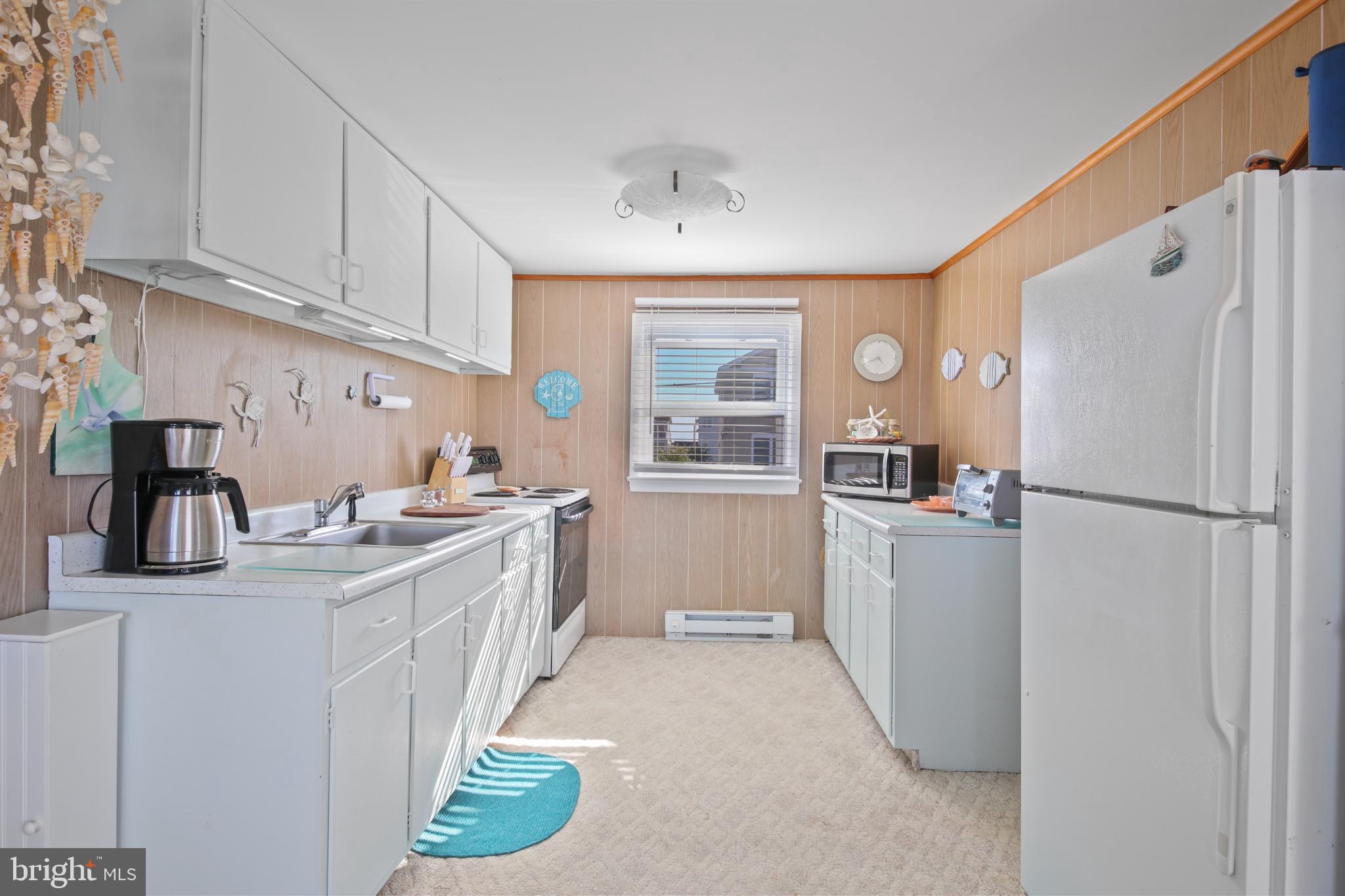 33 Adrian Road Long Beach Township, NJ 08006 - Photo 16 of 31 a kitchen with a refrigerator and a sink