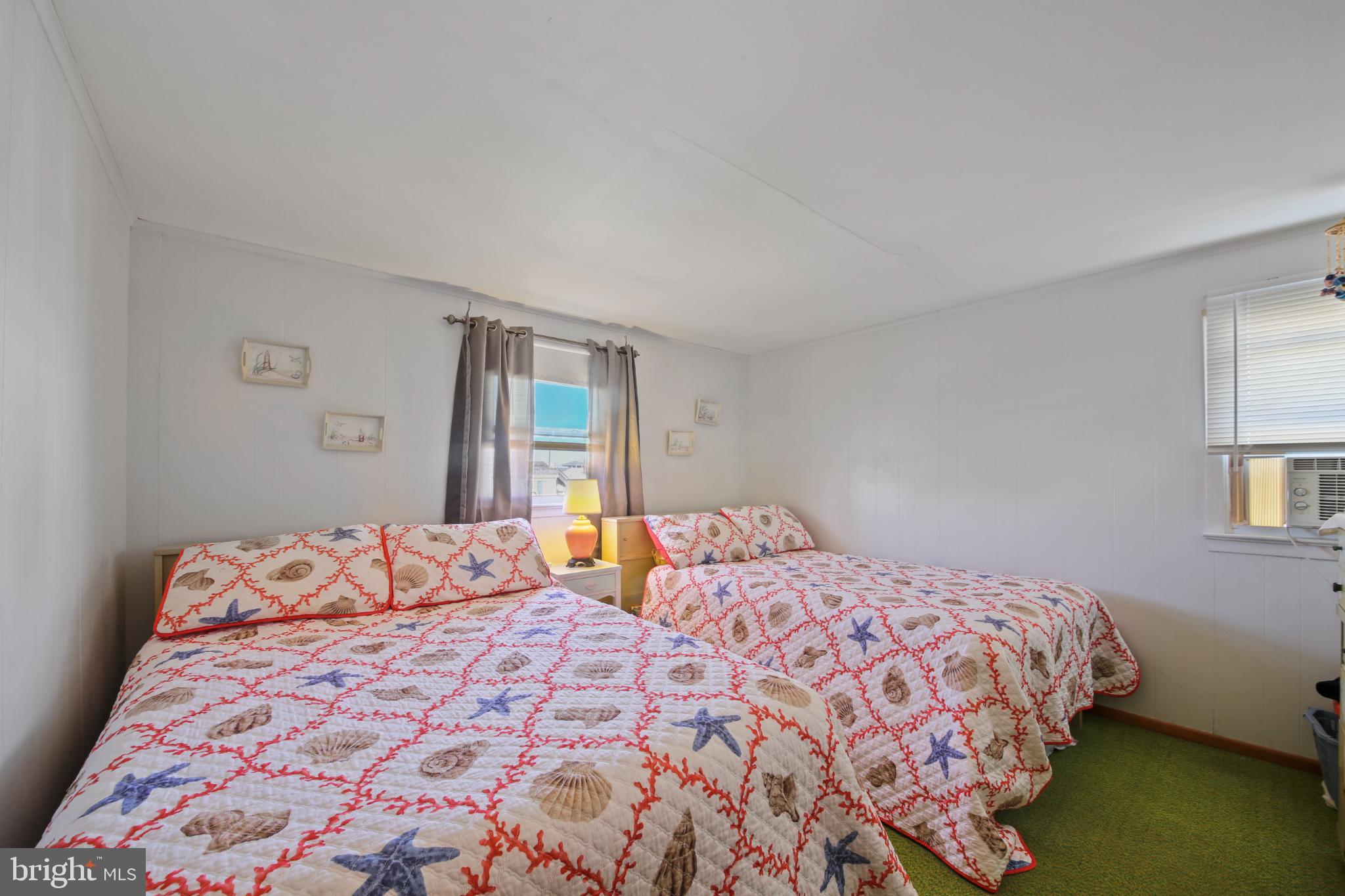 33 Adrian Road Long Beach Township, NJ 08006 - Photo 24 of 31 a bedroom with a large bed and a window
