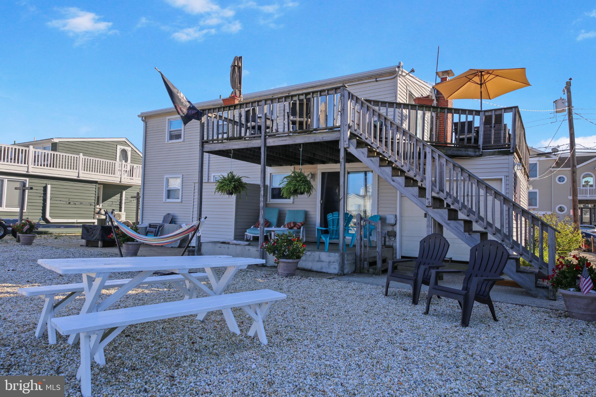 33 Adrian Road Long Beach Township, NJ 08006 - Photo 28 of 31 a view of a house with backyard and sitting area