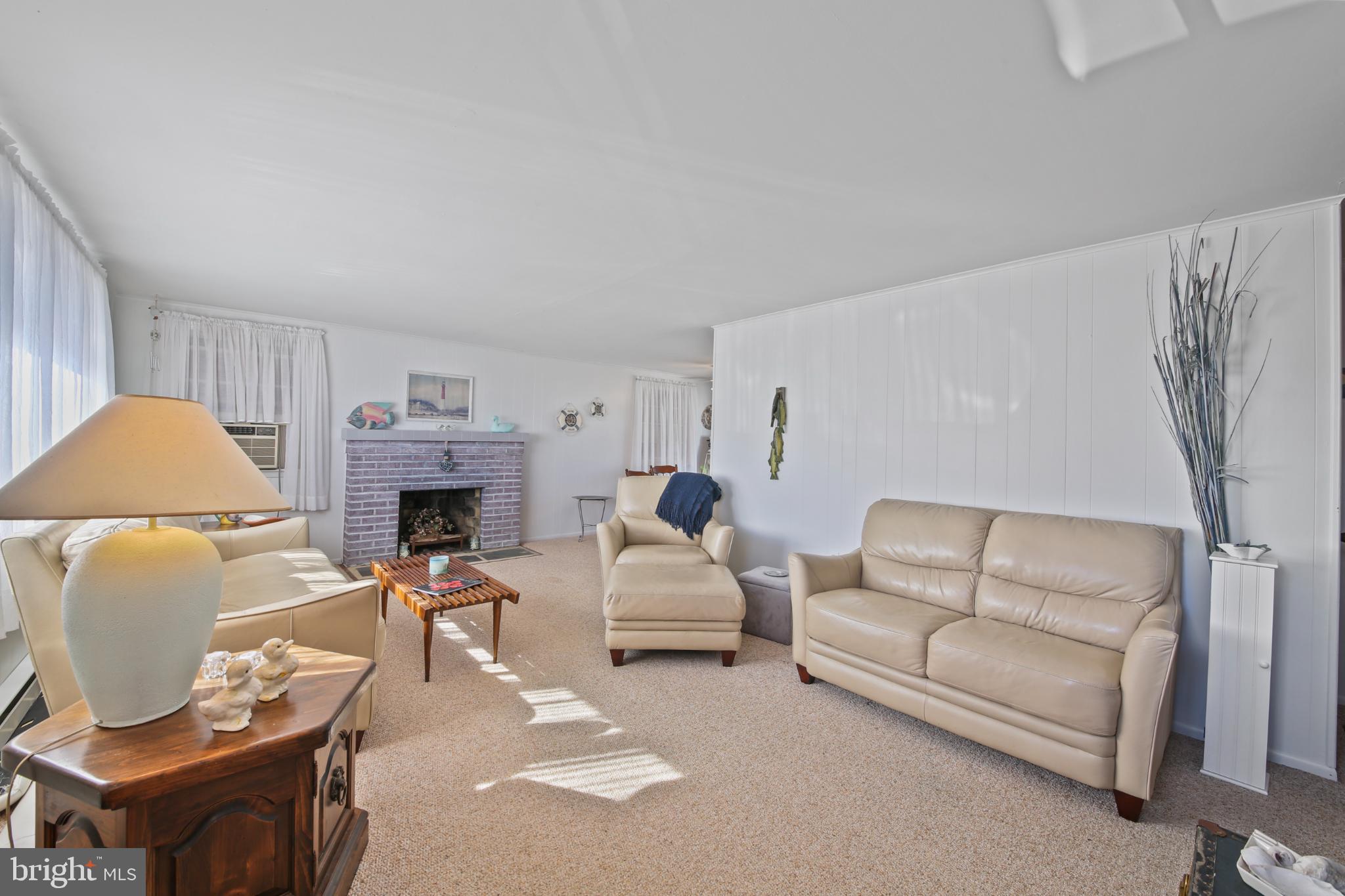 33 Adrian Road Long Beach Township, NJ 08006 - Photo 7 of 31 a living room with furniture and a fireplace