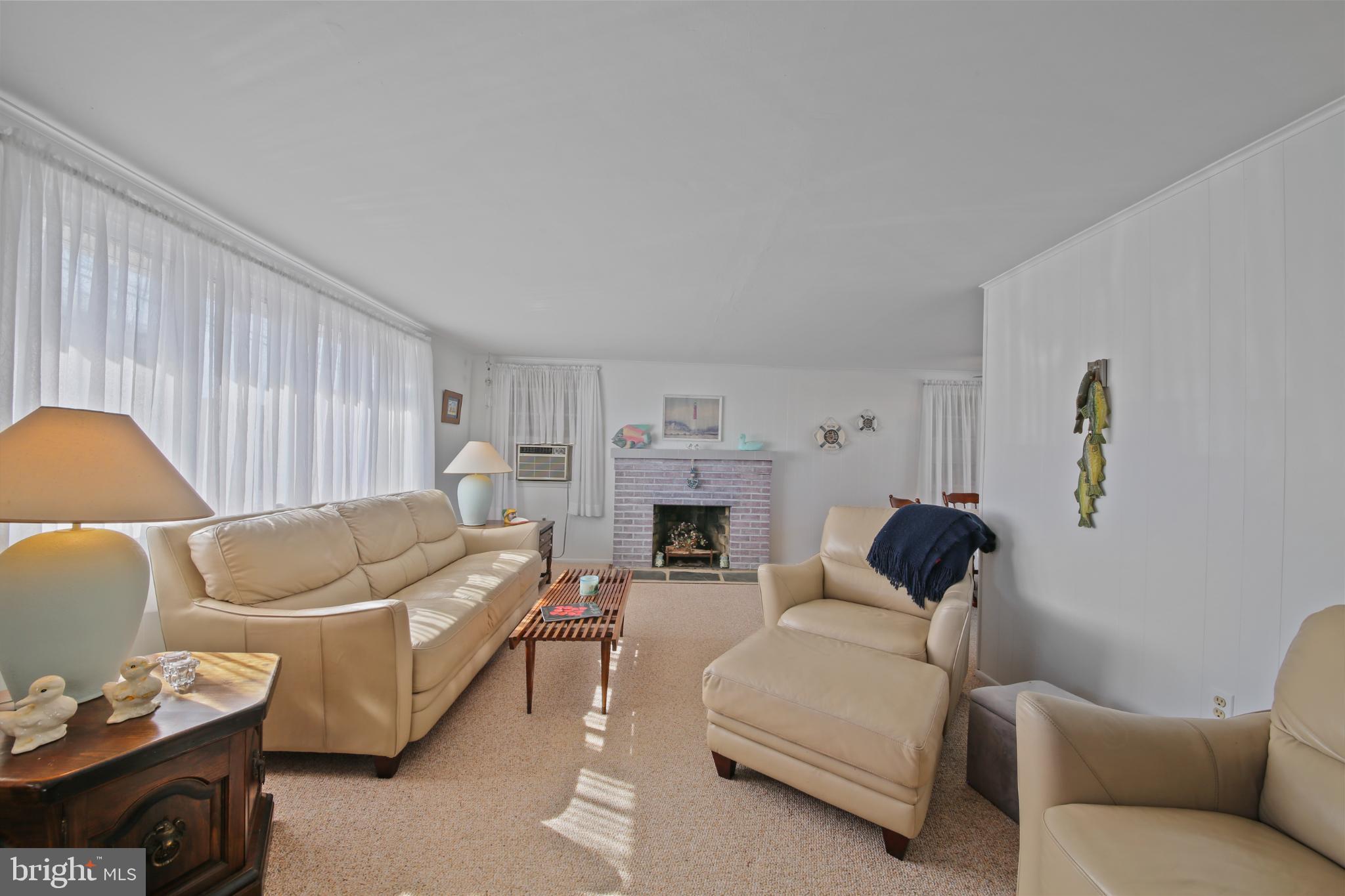 33 Adrian Road Long Beach Township, NJ 08006 - Photo 8 of 31 a living room with furniture and a fireplace