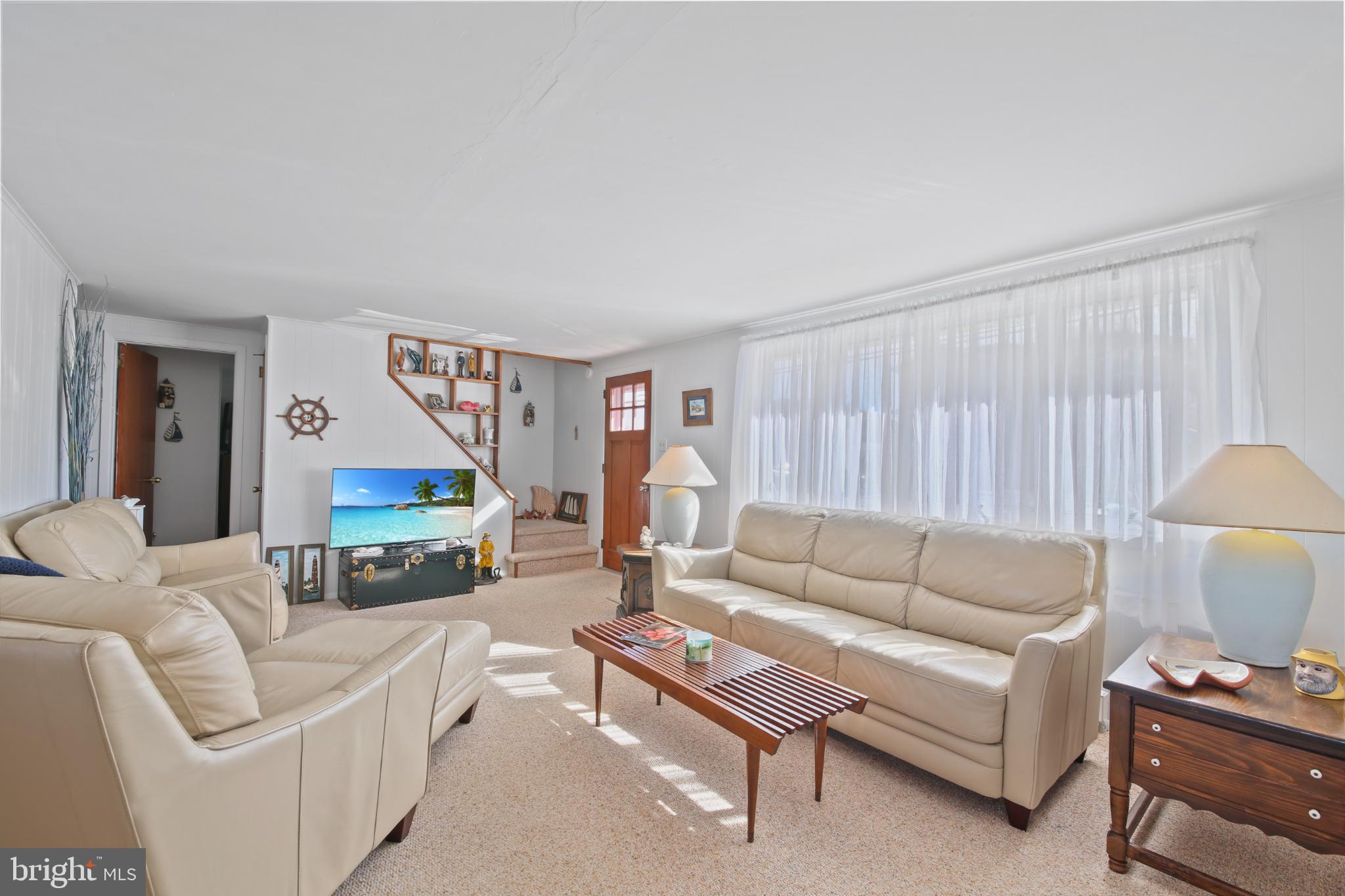 33 Adrian Road Long Beach Township, NJ 08006 - Photo 9 of 31 a living room with furniture a rug and a lamp
