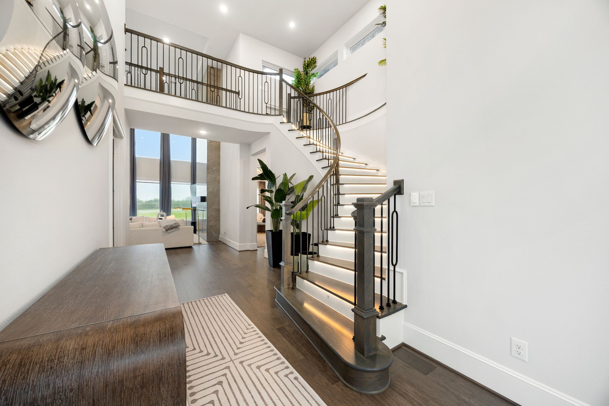 29419 Cir S Rnch Trail Fulshear, TX 77406 - Photo 4 of 45 Things We Love #2- This architectural curved staircase features contemporary style, features motion-activated lighting that softly illuminates each step, creating a striking architectural feature.