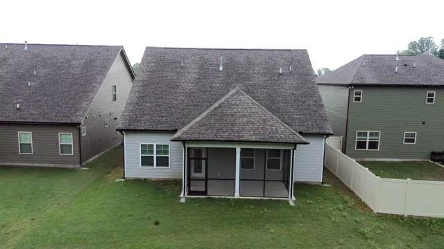 a aerial view of a house with a garden and deck