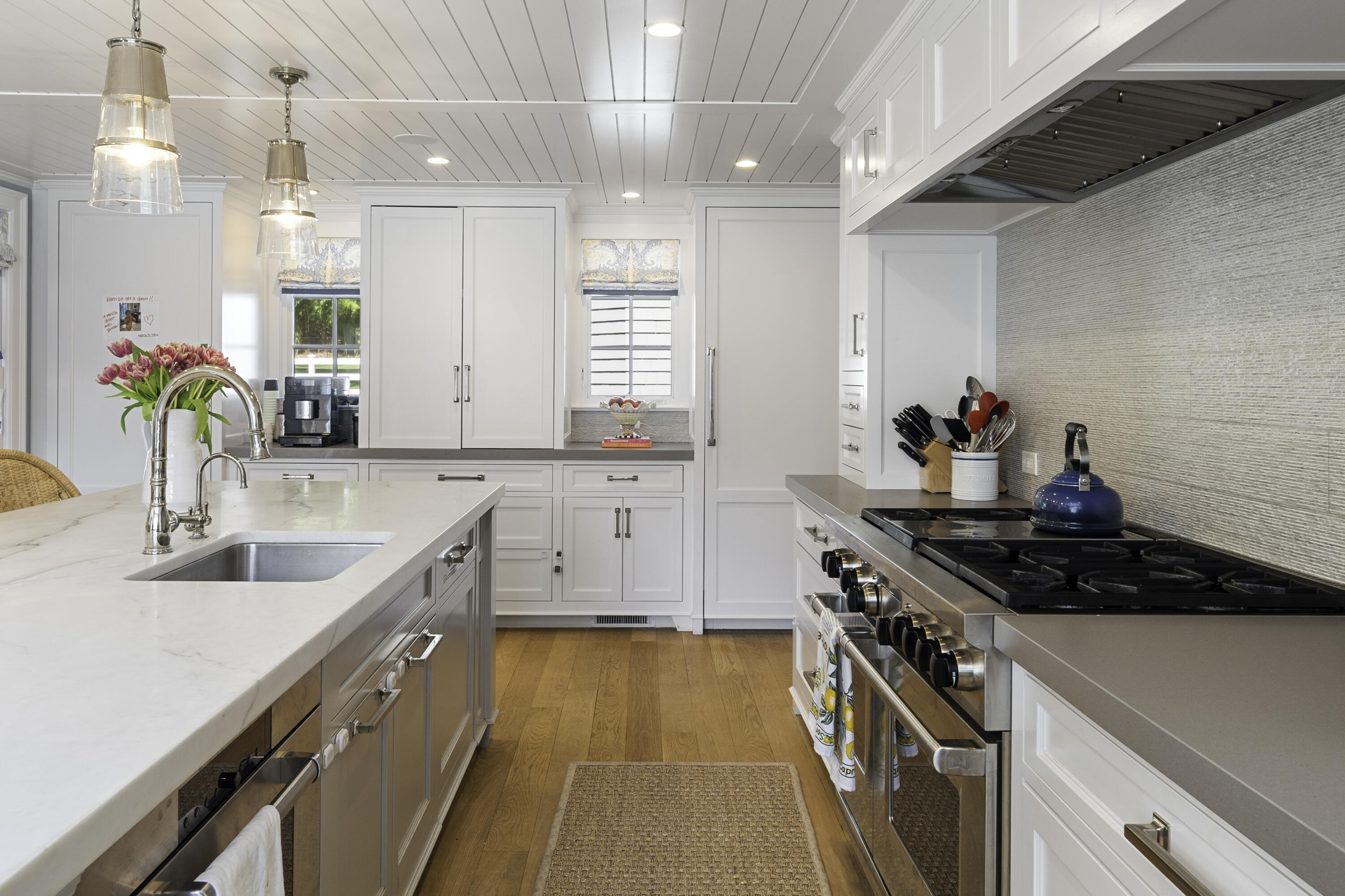 31 Bayberry Road New Canaan, CT 06840 - Photo 15 of 47 a kitchen that has a sink and a stove with wooden floors