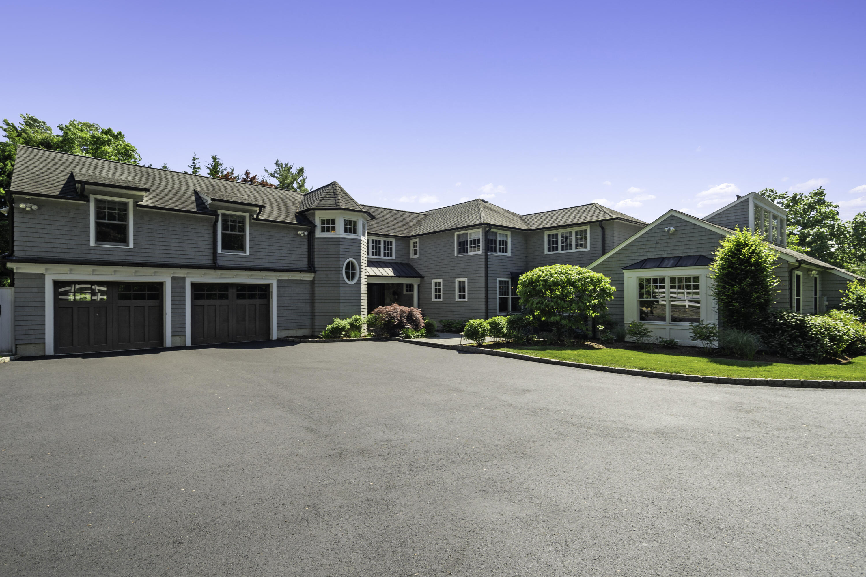 31 Bayberry Road New Canaan, CT 06840 - Photo 3 of 47 a front view of a house with a yard and garage
