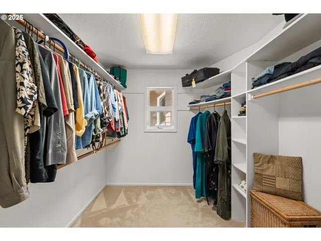 a view of walk in closet with clothes