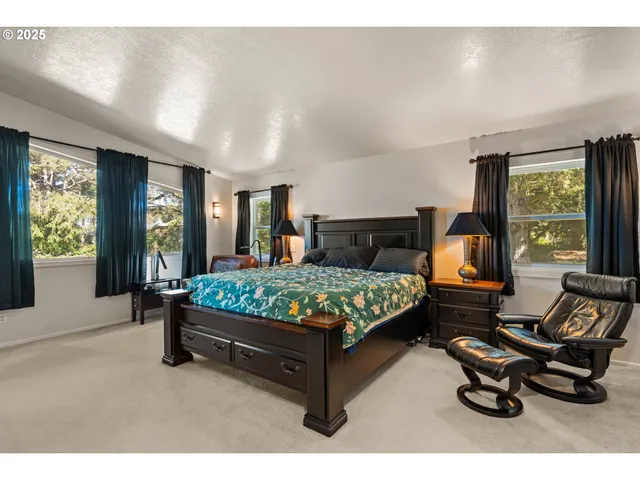 a bedroom with a bed chair and window