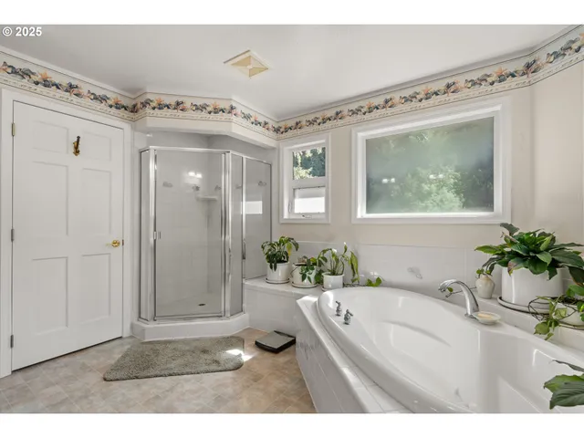 a view of a bathroom with a tub shower and mirror