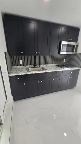 a kitchen with sink and cabinets