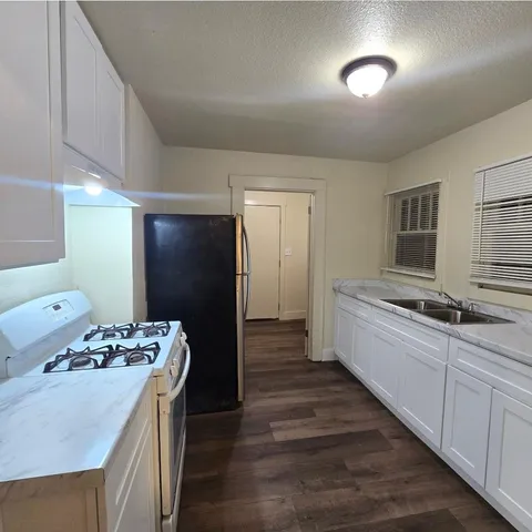 a kitchen with a sink and refrigerator