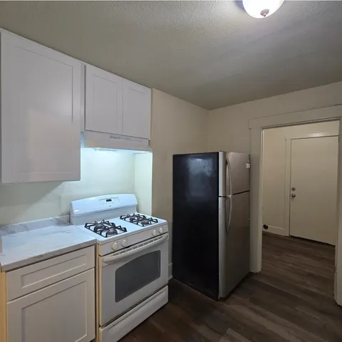 a kitchen with a stove and a refrigerator
