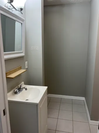 a room with a sink and cabinets