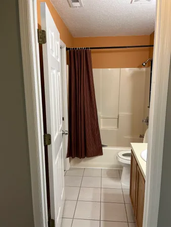 a bathroom with a shower a toilet and a shower
