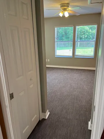 a view of a livingroom with a window and wooden floor