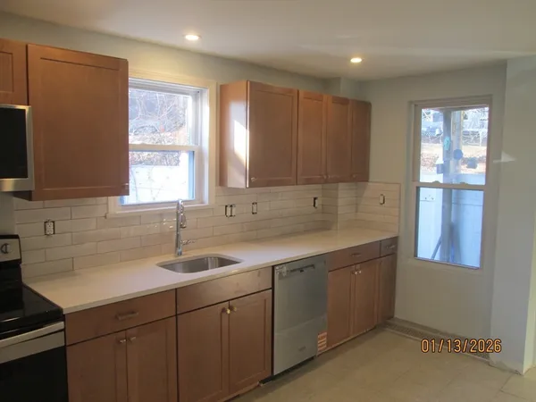 a kitchen with sink cabinets and window
