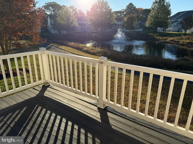 a view of balcony with wooden floor and fence
