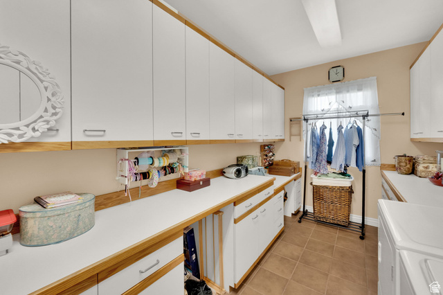 7740 Keswick Road Sandy, UT 84093 - Photo 27 of 74 Utility room featuring extensive white cabinetry with wood-finish trim, white countertops, and durable tile flooring