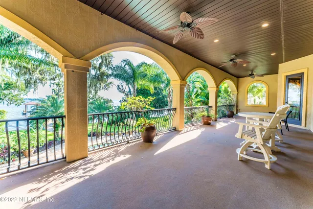 a bed room with a bed mirror and a ceiling fan