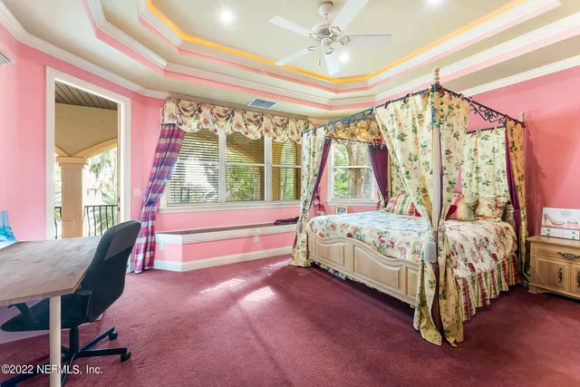 an aerial view of a house with a yard and lake view