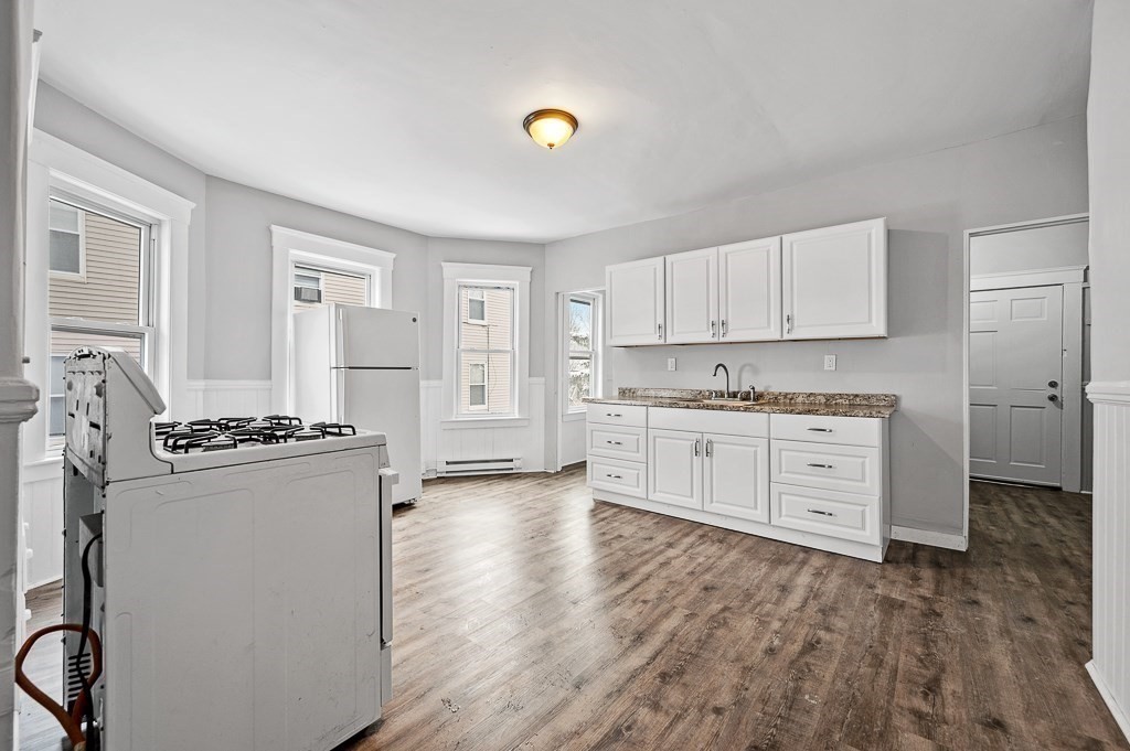 256 Belmont Street Worcester, MA 01604 - Photo 15 of 40 a kitchen with white cabinets and white appliances