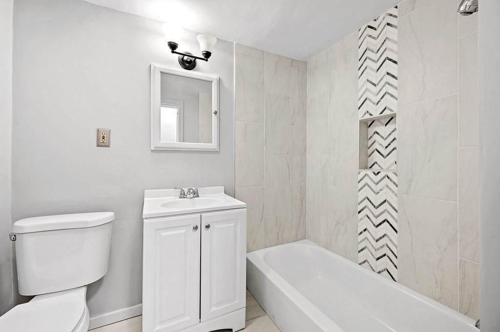 256 Belmont Street Worcester, MA 01604 - Photo 30 of 40 a bathroom with a sink a toilet and a bathtub