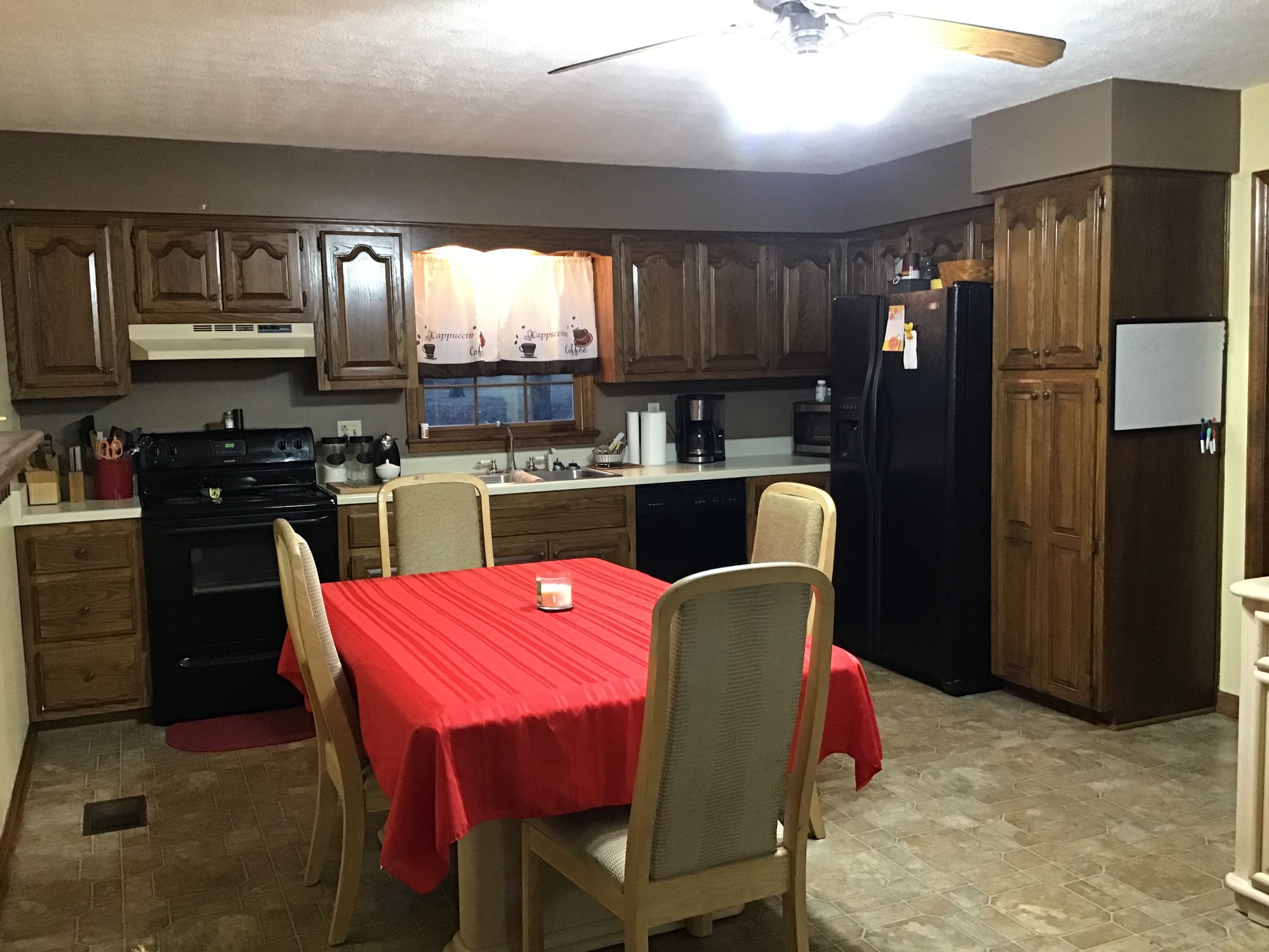 6830 Hester Road Springfield, TN 37172 - Photo 7 of 28 a kitchen with stainless steel appliances granite countertop a dining table chairs refrigerator and cabinets