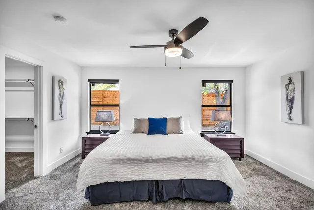 a bedroom with a large bed and a chandelier