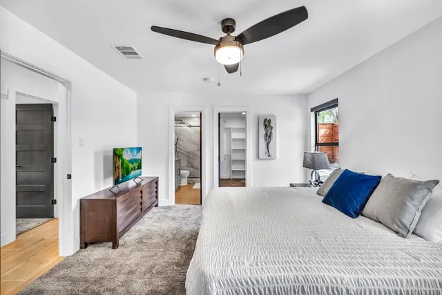 a bedroom with a balcony a bed and a chandelier