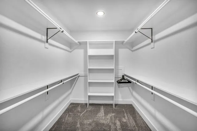 a view of walk in closet with empty racks