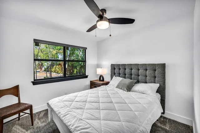 a bedroom with a large bed and a window