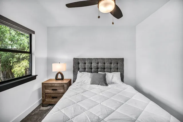 a bedroom with a bed and window